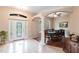 Bright dining area with a formal dining table, decorative columns, and a view of the front yard, perfect for Gathering gatherings at 3826 E 155Th E Ave, Parrish, FL 34219