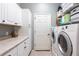 Laundry room with modern washer/dryer, utility sink and ample cabinet space at 3826 E 155Th E Ave, Parrish, FL 34219
