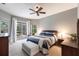 Primary bedroom with ceiling fan, access to the screened lanai, and ensuite bathroom at 3826 E 155Th E Ave, Parrish, FL 34219