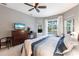 Comfortable main bedroom featuring a ceiling fan, ample natural light, and views of the pool at 3826 E 155Th E Ave, Parrish, FL 34219