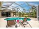 Screened-in pool area with lounge chairs and a view of natural landscaping at 3826 E 155Th E Ave, Parrish, FL 34219