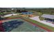 Aerial view of a recreational area with a basketball court, playground, pond, and covered picnic area at 3826 E 155Th E Ave, Parrish, FL 34219