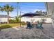 Paver patio with seating area and shady umbrella perfect for outdoor lounging at 6708 Keystone Dr, Sarasota, FL 34231