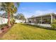 Sprawling backyard featuring tropical foliage, a stone patio, and outdoor seating at 6708 Keystone Dr, Sarasota, FL 34231