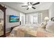 Bedroom featuring a ceiling fan, tv, and a decorative bedspread at 6708 Keystone Dr, Sarasota, FL 34231