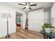 Bright room featuring wood floors, a murphy bed, ship lap accent wall, and a ceiling fan at 6708 Keystone Dr, Sarasota, FL 34231