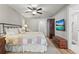 Bedroom featuring a ceiling fan, television, and wooden furniture at 6708 Keystone Dr, Sarasota, FL 34231