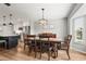 Cozy dining area featuring wood floors, a modern light fixture, and views into the kitchen at 6708 Keystone Dr, Sarasota, FL 34231