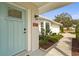 Close-up of the front door, highlighting the address, stylish light fixture, and beautiful landscaping details at 6708 Keystone Dr, Sarasota, FL 34231