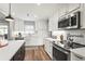 Bright kitchen with stainless steel appliances, white cabinets, and modern countertops at 6708 Keystone Dr, Sarasota, FL 34231