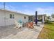 This outdoor patio features pavers, chairs, table, umbrella and access to a screened in porch at 6708 Keystone Dr, Sarasota, FL 34231