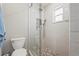 Modern bathroom shower featuring a glass door, subway tile, and stone floor at 6708 Keystone Dr, Sarasota, FL 34231