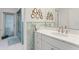 Updated bathroom featuring blue and white patterned tile and a bright white vanity at 7056 Hawks Harbor Cir, Bradenton, FL 34207