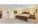 A well-lit main bedroom boasts a plush bed and neutral carpeting at 7056 Hawks Harbor Cir, Bradenton, FL 34207