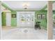 Bright foyer featuring tile flooring, elegant lighting, and a view through the front door at 7056 Hawks Harbor Cir, Bradenton, FL 34207