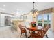 Bright kitchen featuring stainless steel appliances, wooden table, and garden view at 7056 Hawks Harbor Cir, Bradenton, FL 34207