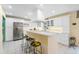 Spacious kitchen with white cabinetry, stainless steel appliances, and a large island with bar seating at 7056 Hawks Harbor Cir, Bradenton, FL 34207