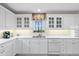 Bright white kitchen with custom cabinets, stone countertops and stainless steel appliances at 7056 Hawks Harbor Cir, Bradenton, FL 34207
