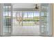The screened lanai overlooks a canal with tropical foliage beyond the decorative railing at 7056 Hawks Harbor Cir, Bradenton, FL 34207
