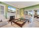 Cozy living room features tile flooring, a fireplace, and access to the lanai at 7056 Hawks Harbor Cir, Bradenton, FL 34207