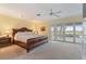 Serene main bedroom with large bed, ample closet space and access to the lanai at 7056 Hawks Harbor Cir, Bradenton, FL 34207