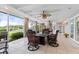 Relaxing screened-in patio offers ample seating with a view to the lush landscaping and boats on the water at 7056 Hawks Harbor Cir, Bradenton, FL 34207