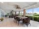 Relaxing screened-in patio offers ample seating with a view to the water and lush landscaping at 7056 Hawks Harbor Cir, Bradenton, FL 34207