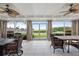 Bright sunroom with tile flooring, ceiling fans and a view of the waterfront at 7056 Hawks Harbor Cir, Bradenton, FL 34207
