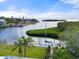 Waterfront view of dock and boat amid lush foliage and bay view at 7056 Hawks Harbor Cir, Bradenton, FL 34207