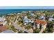 Aerial view of coastal home surrounded by palm trees, lush landscaping, and a private driveway in a residential area at 718 Key Royale Dr, Holmes Beach, FL 34217