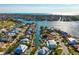 Waterfront home nestled on a canal, boasting a private boat dock, sparkling pool, and tropical landscaping at 718 Key Royale Dr, Holmes Beach, FL 34217
