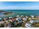 Waterfront home with lush landscaping, a private boat dock, and an inviting pool, perfect for relaxation at 718 Key Royale Dr, Holmes Beach, FL 34217