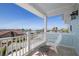 Inviting balcony with ocean views, a white chair, and a small table, ideal for enjoying the scenery at 718 Key Royale Dr, Holmes Beach, FL 34217