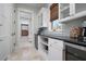 Chic bar area with wine and beverage refrigerators, granite countertops, and glass-front cabinets at 718 Key Royale Dr, Holmes Beach, FL 34217