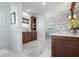Luxurious bathroom featuring marble floors, a glass-enclosed shower, and custom wood cabinetry at 718 Key Royale Dr, Holmes Beach, FL 34217