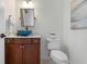 Chic powder room with blue glass vessel sink and dark wood vanity at 718 Key Royale Dr, Holmes Beach, FL 34217
