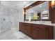 Stunning bathroom with marble, custom cabinets, and a glass shower, providing a luxurious retreat at 718 Key Royale Dr, Holmes Beach, FL 34217