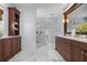Elegant bathroom with marble floors, glass shower, and custom cabinets, creating a spa-like experience at 718 Key Royale Dr, Holmes Beach, FL 34217
