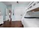Bedroom featuring a white bunk bed, dark hardwood floors, white doors and trim at 718 Key Royale Dr, Holmes Beach, FL 34217