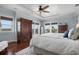 Bright bedroom with ocean views, a ceiling fan, hardwood floors, and ample natural light at 718 Key Royale Dr, Holmes Beach, FL 34217