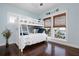 Bright bedroom with a white bunk bed, dark hardwood floors, and charming beach decor at 718 Key Royale Dr, Holmes Beach, FL 34217