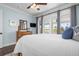 Calm bedroom features light blue walls, white bedding, and large windows with balcony access at 718 Key Royale Dr, Holmes Beach, FL 34217