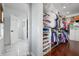 Well-organized walk-in closet with ample storage, shelving, and a view of the marble entryway at 718 Key Royale Dr, Holmes Beach, FL 34217