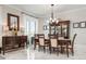 Elegant dining room with dark wood furniture, chandelier, and access to an outdoor space at 718 Key Royale Dr, Holmes Beach, FL 34217