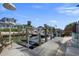 Well-maintained boat dock in a waterfront community with several jet skis on boat lifts at 718 Key Royale Dr, Holmes Beach, FL 34217