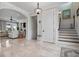 Welcoming foyer with staircase, elegant lighting, and views into the adjacent living room at 718 Key Royale Dr, Holmes Beach, FL 34217