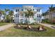 Beautiful coastal home with manicured front yard and double garage at 718 Key Royale Dr, Holmes Beach, FL 34217