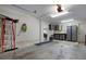 Clean garage with painted walls, storage cabinets, a work bench, tile accents, and interior access to the home at 718 Key Royale Dr, Holmes Beach, FL 34217