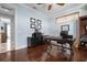 Well-organized home office featuring dark wood floors, a desk, and storage at 718 Key Royale Dr, Holmes Beach, FL 34217