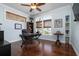 Bright home office featuring hardwood floors, dark wood furniture, and natural light at 718 Key Royale Dr, Holmes Beach, FL 34217